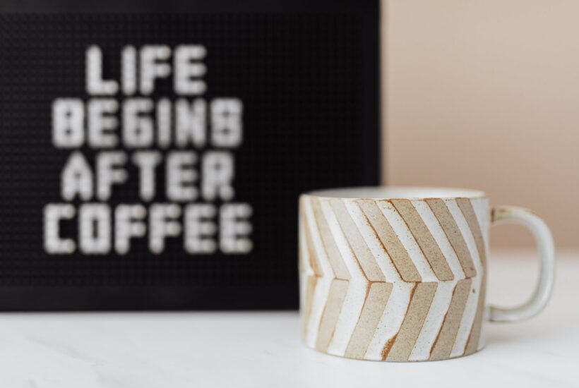 cup of coffee and peg message board with funny title